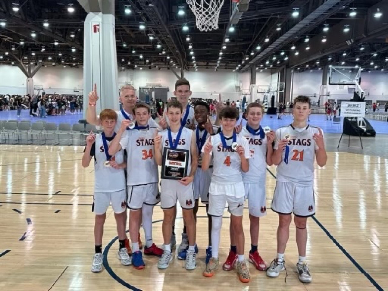 Idaho Stags team celebrates a tournament championship with medals